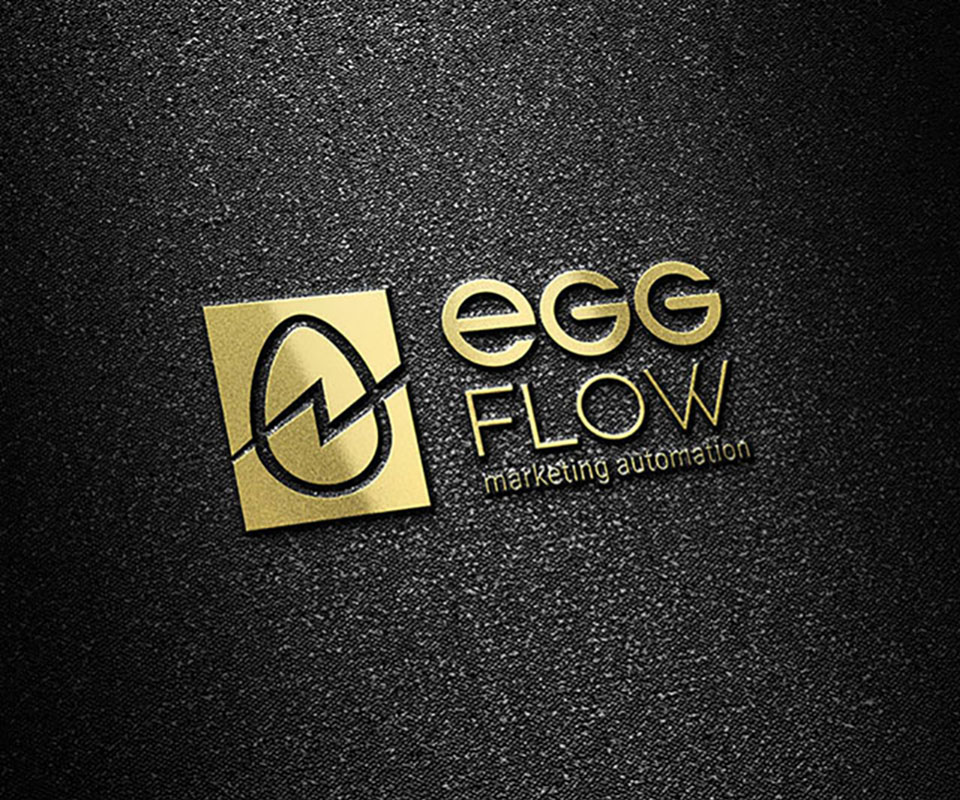 The EggFlow logo in gold foil, the egg mark and flow line standing out clearly