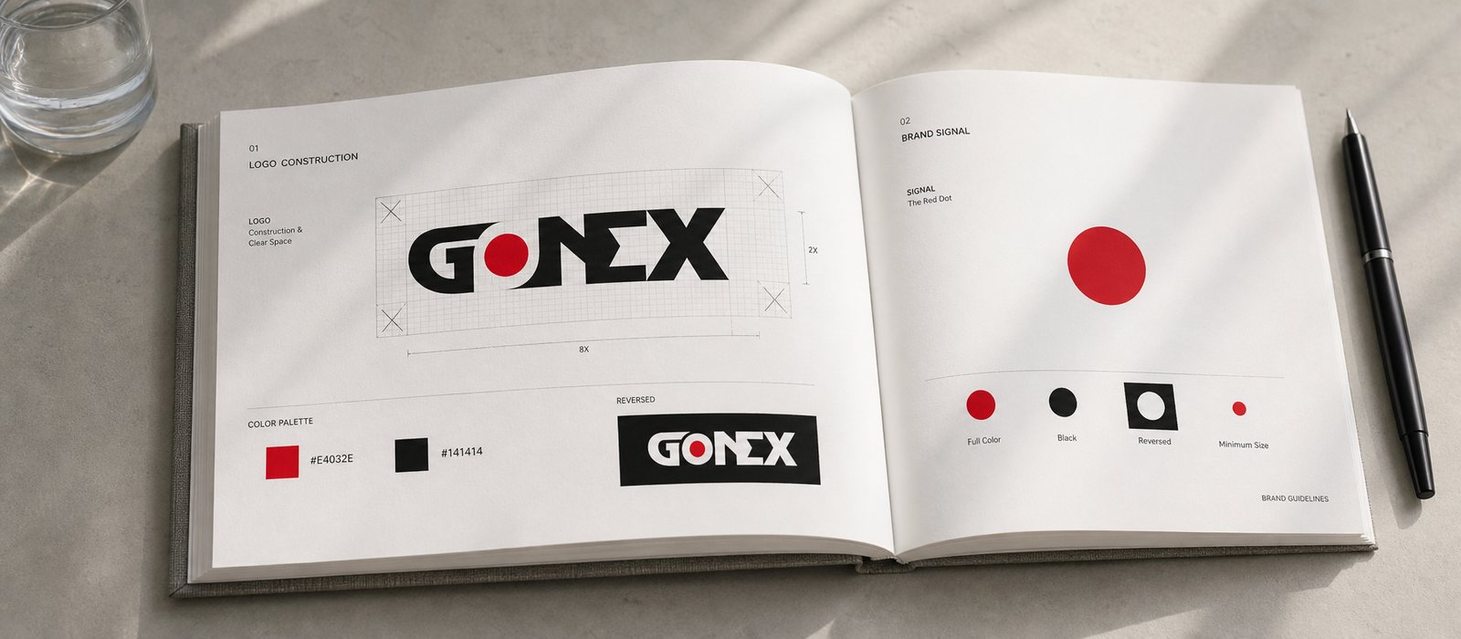 Gonext guideline book open to a logo construction page: proportion grid, breathing space, red and black color palette, the red signal dot