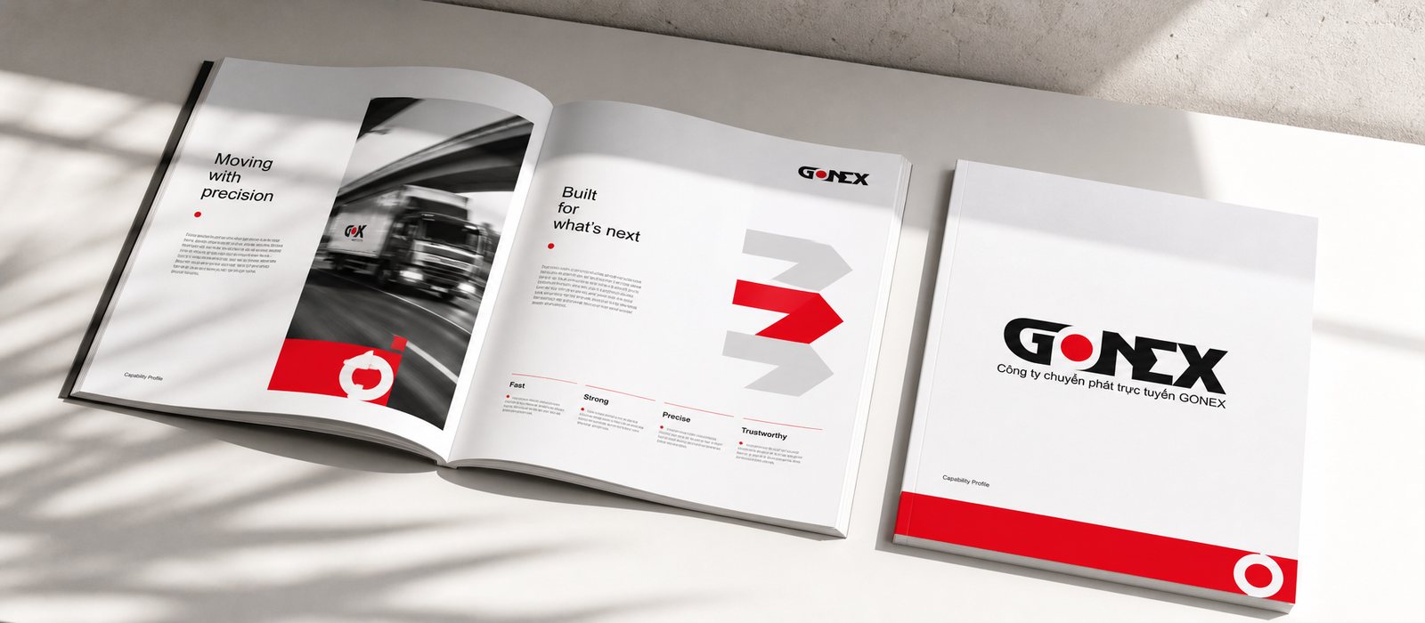 Gonext corporate profile open to a spread: a clean two-page layout, the red dot and the GONEX letterform leading the eye