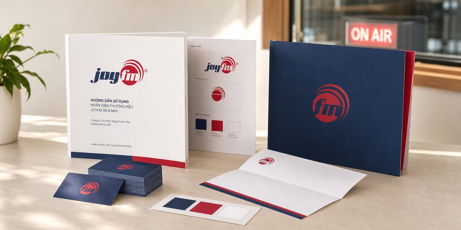 The JoyFM logo, the word joy in navy beside a red broadcast-wave mark