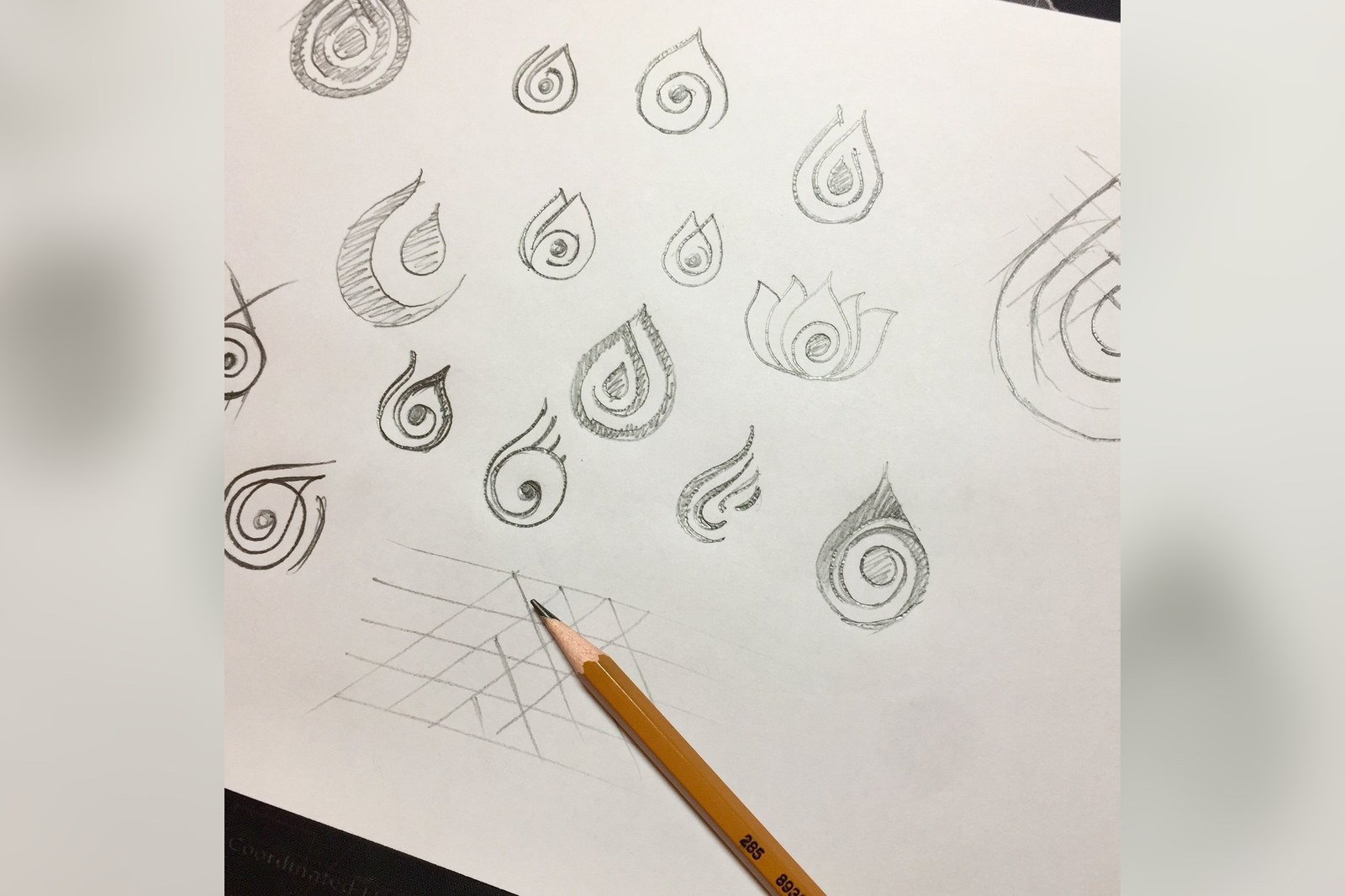 Hand-drawn sketch page of LiuGems mark routes, many spiral droplet variants in pencil on white paper