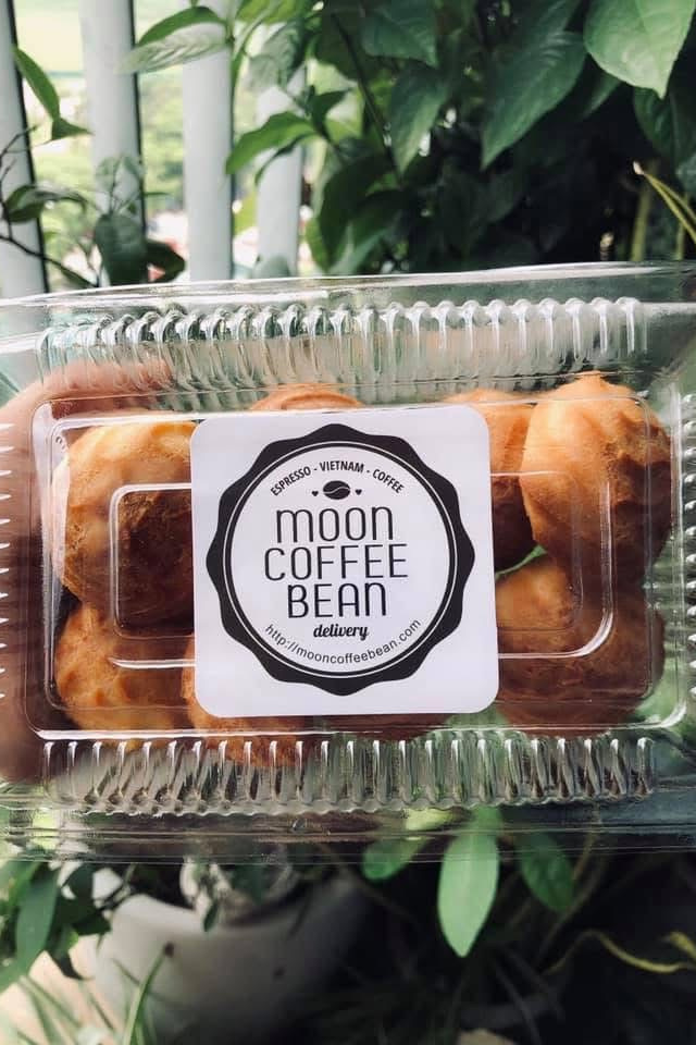A plastic croissant tray carrying the Moon Coffee Bean seal