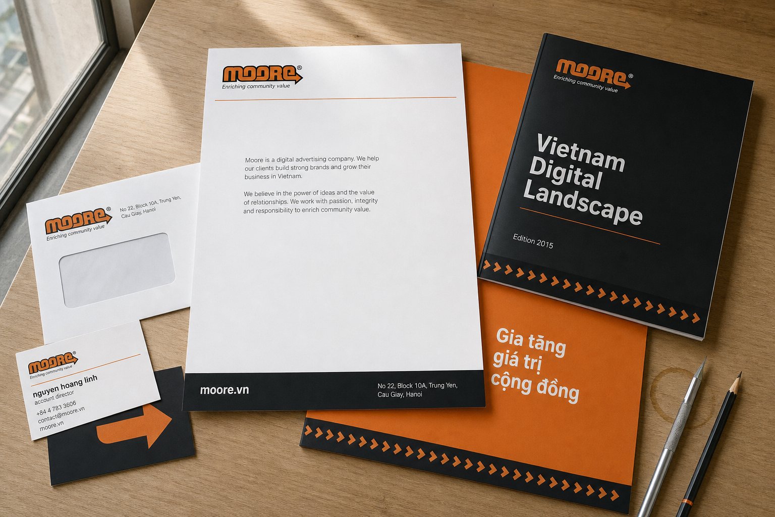 The full Moore stationery set: letterhead, envelope, business cards, orange folder and the Vietnam Digital Landscape report