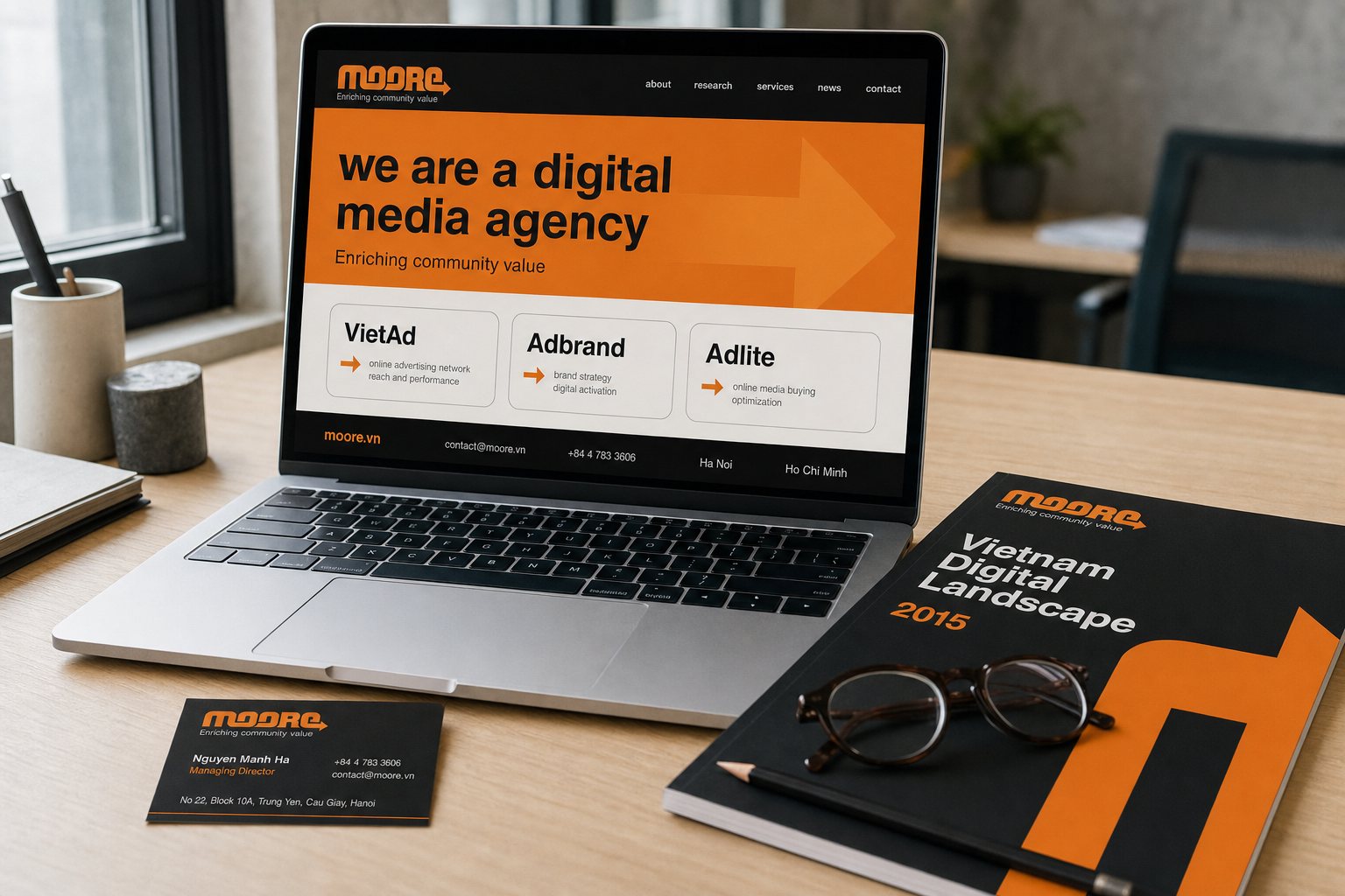 The moore.vn home page The Moore home page on a laptop, an orange band carrying the tagline above the VietAd, Adbrand and Adlite platforms